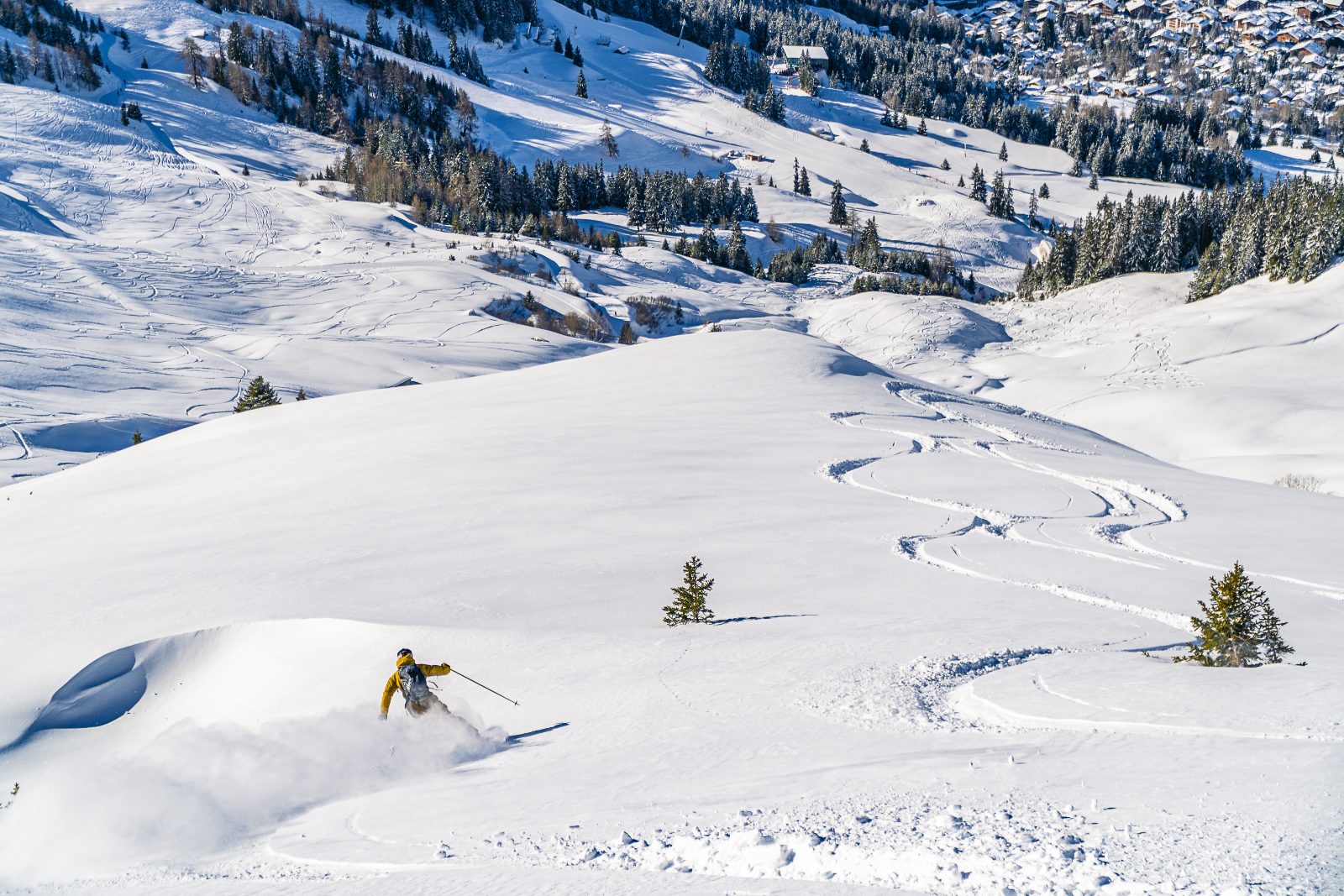 Prepare your ski holiday: skier on a groomed slope at the start of the season